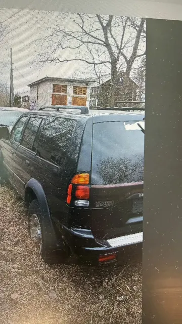 Транспортное средство Mitsubishi Montero Sport 4WD, 2002 года выпуска, цвет - черный, VIN JA4MT21H62J061420, государственный номер E965MM29, небольшие вмятины на заднем правом крыле, трещина на заднем бампере